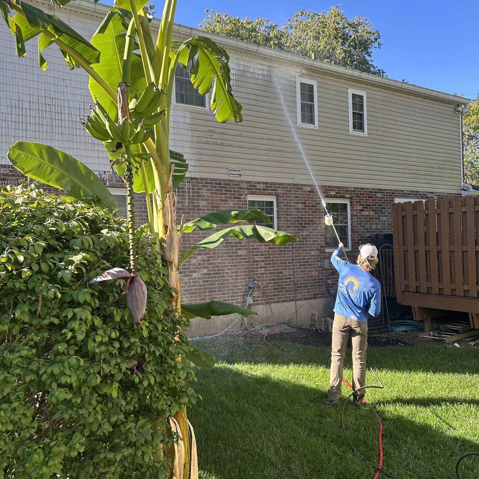 Pressure washing service cleaning a concrete driveway in Cincinnati OH by Brighter Day Exterior Cleaning